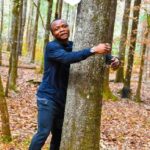 According to Guinness World Records, a Ghanaian activist sets a record by hugging over 1,100 trees in one hour.