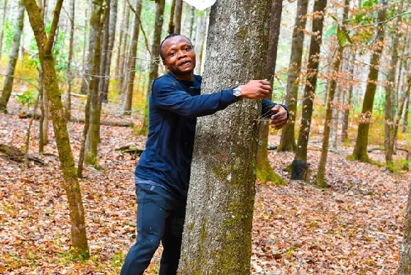 According to Guinness World Records, a Ghanaian activist sets a record by hugging over 1,100 trees in one hour.