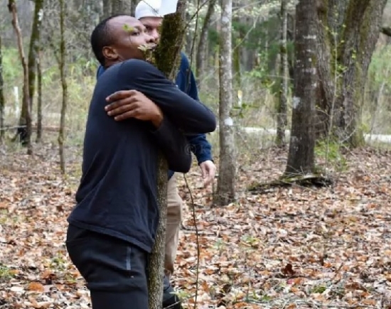 According to Guinness World Records, a Ghanaian activist sets a record by hugging over 1,100 trees in one hour.