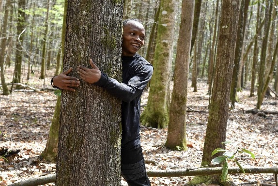 According to Guinness World Records, a Ghanaian activist sets a record by hugging over 1,100 trees in one hour.